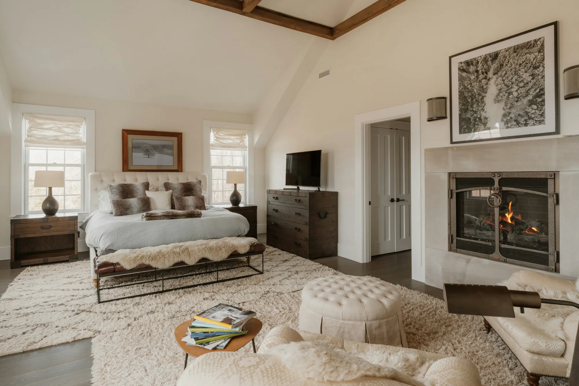 Cozy bedroom with a lit fireplace and soft rugs