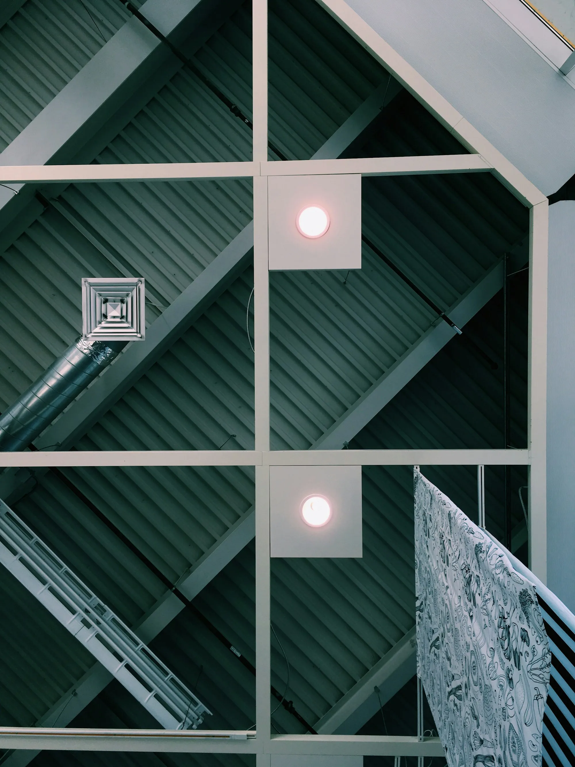 Square supply diffuser on a dark green ceiling